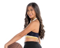 a young woman holding a basketball ball