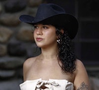 a woman wearing a black cowboy hat