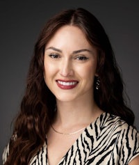 a woman in a zebra print shirt is smiling