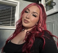 a woman with red hair posing for a selfie
