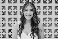 a black and white photo of a woman smiling